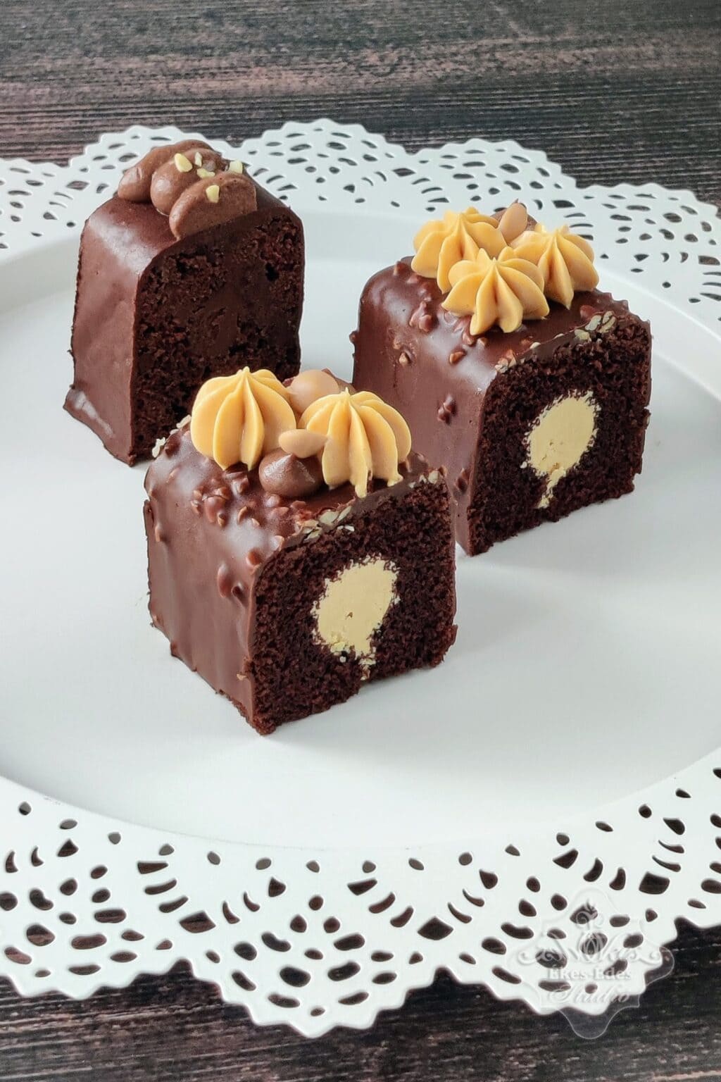 Csokoládés travel cake szeletek, töltött vaníliás krémmel, díszített csokoládéval és mandulával.