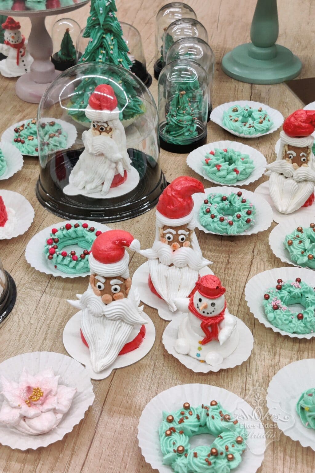 Hóember, mikulás fej, adventi koszorúcskák, nagy karácsonyfa és kisebb fenyő figurák, kézműves pillecukor édességek az Ékes-Édes Stúdióban.